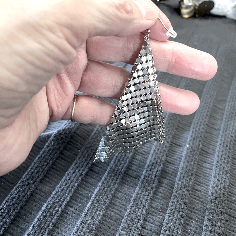 Sequin-like sterling silver flexible earrings.